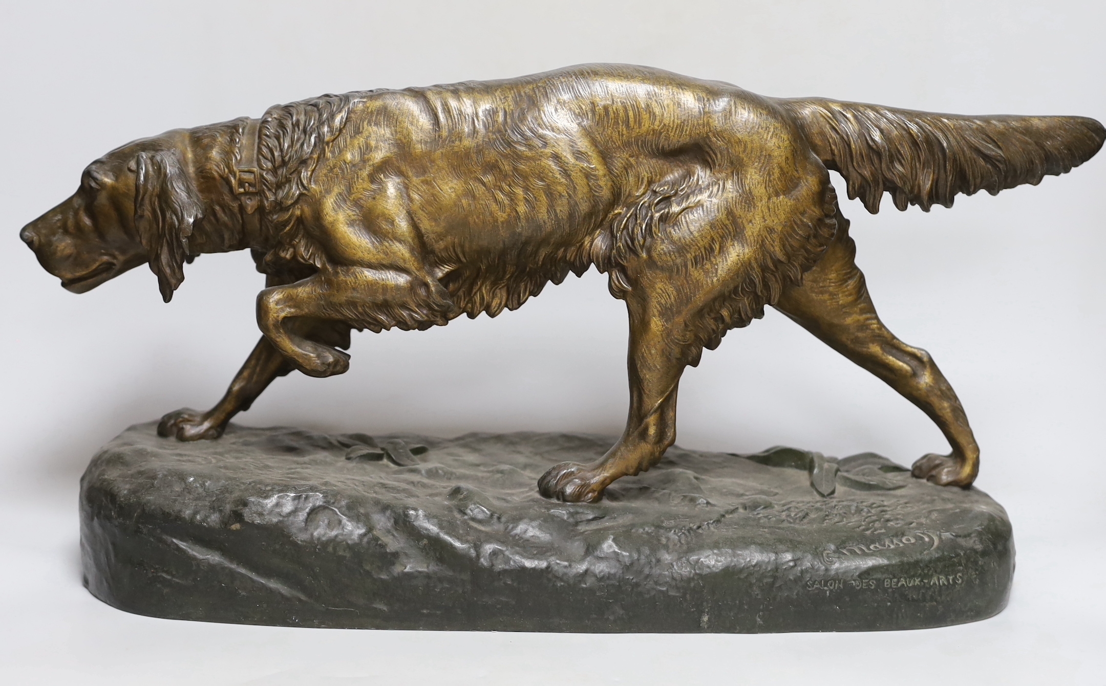 A painted spelter model of a retriever, 49cm wide, 29cm high